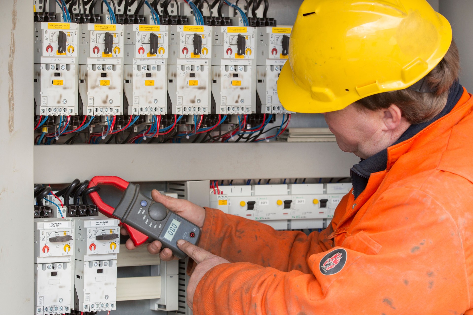 Electrician at work with his instrument of measurement.